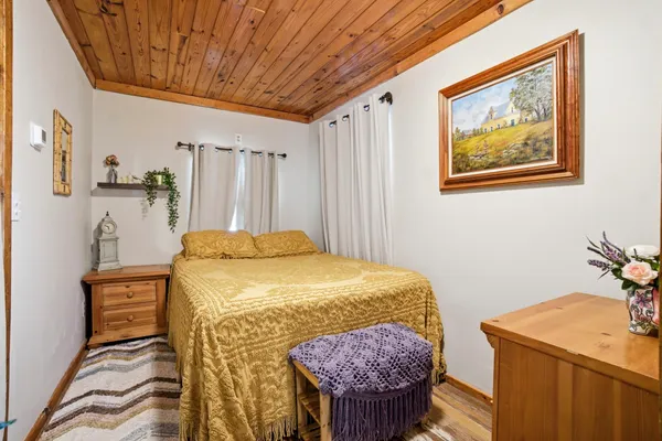 a bedroom with a bed and a table in it