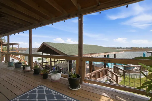 a view of a balcony with chairs and wooden floor