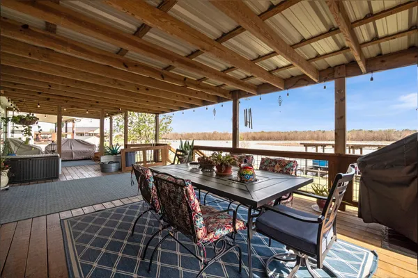 a dining room with furniture and a rug