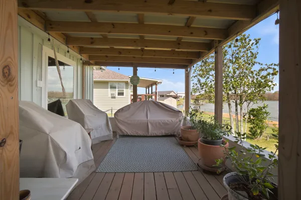 a balcony with furniture and wooden floor
