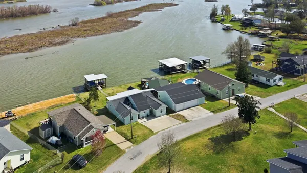 a view of yard from deck with patio