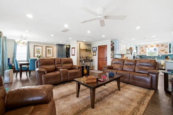 a living room with furniture or kitchen view and a wooden floor