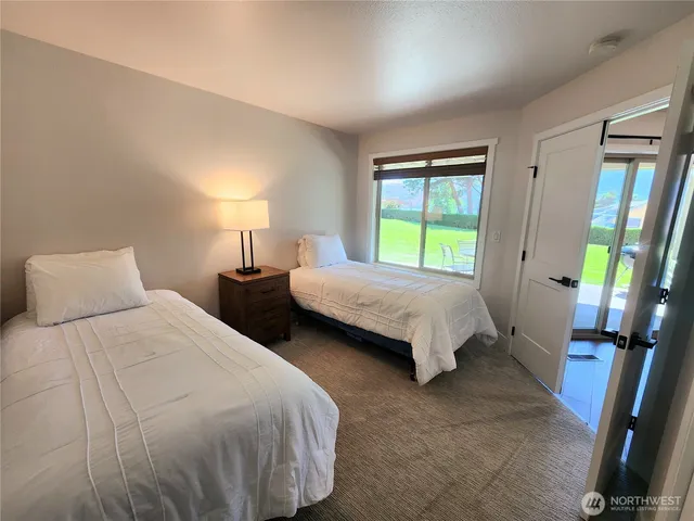 a bedroom with two beds and a window