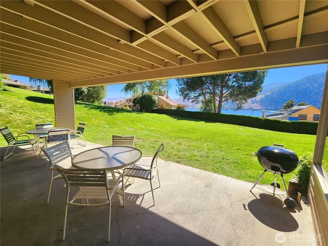 a view of a patio with table and chairs and potted plants