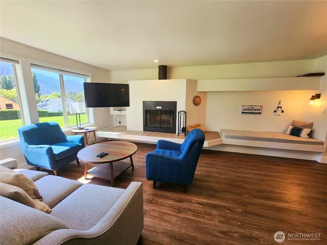 a living room with furniture fireplace and flat screen tv