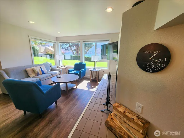 a living room with furniture and a floor to ceiling window