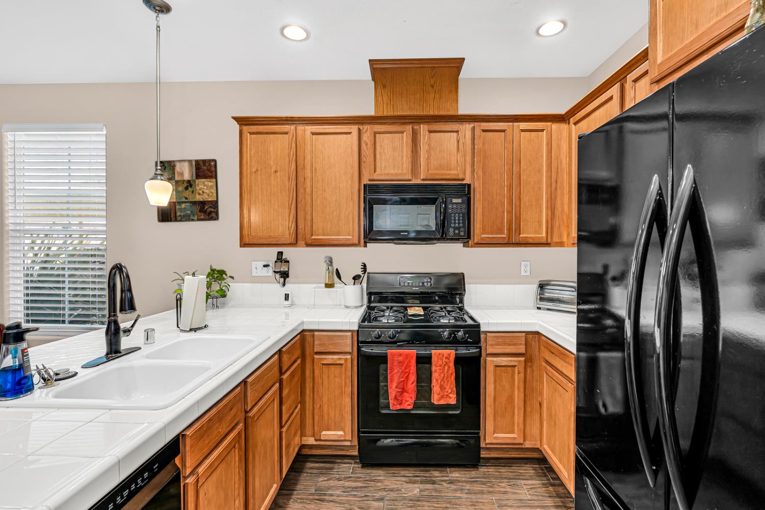 1116 West Walter Avenue, Unit 72 Fowler, CA 93625 - Photo 12 of 31 a kitchen with stainless steel appliances granite countertop a refrigerator a stove top oven a sink and dishwasher
