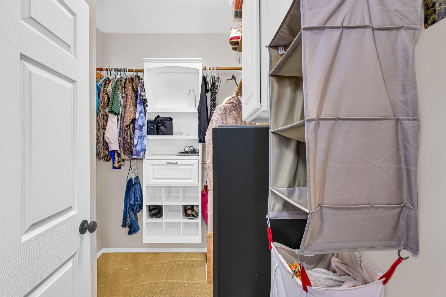 1116 West Walter Avenue, Unit 72 Fowler, CA 93625 - Photo 16 of 31 a view of walk in closet with clothes and shoes
