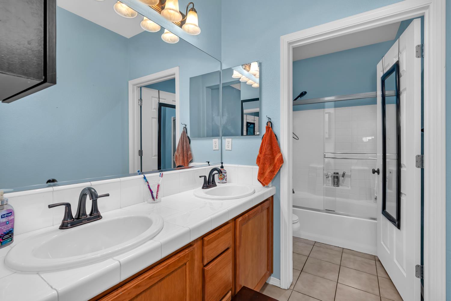 1116 West Walter Avenue, Unit 72 Fowler, CA 93625 - Photo 17 of 31 a bathroom with a sink vanity tub and a mirror