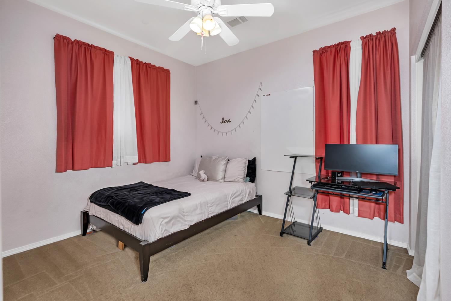 1116 West Walter Avenue, Unit 72 Fowler, CA 93625 - Photo 19 of 31 a bedroom with furniture and a flat screen tv