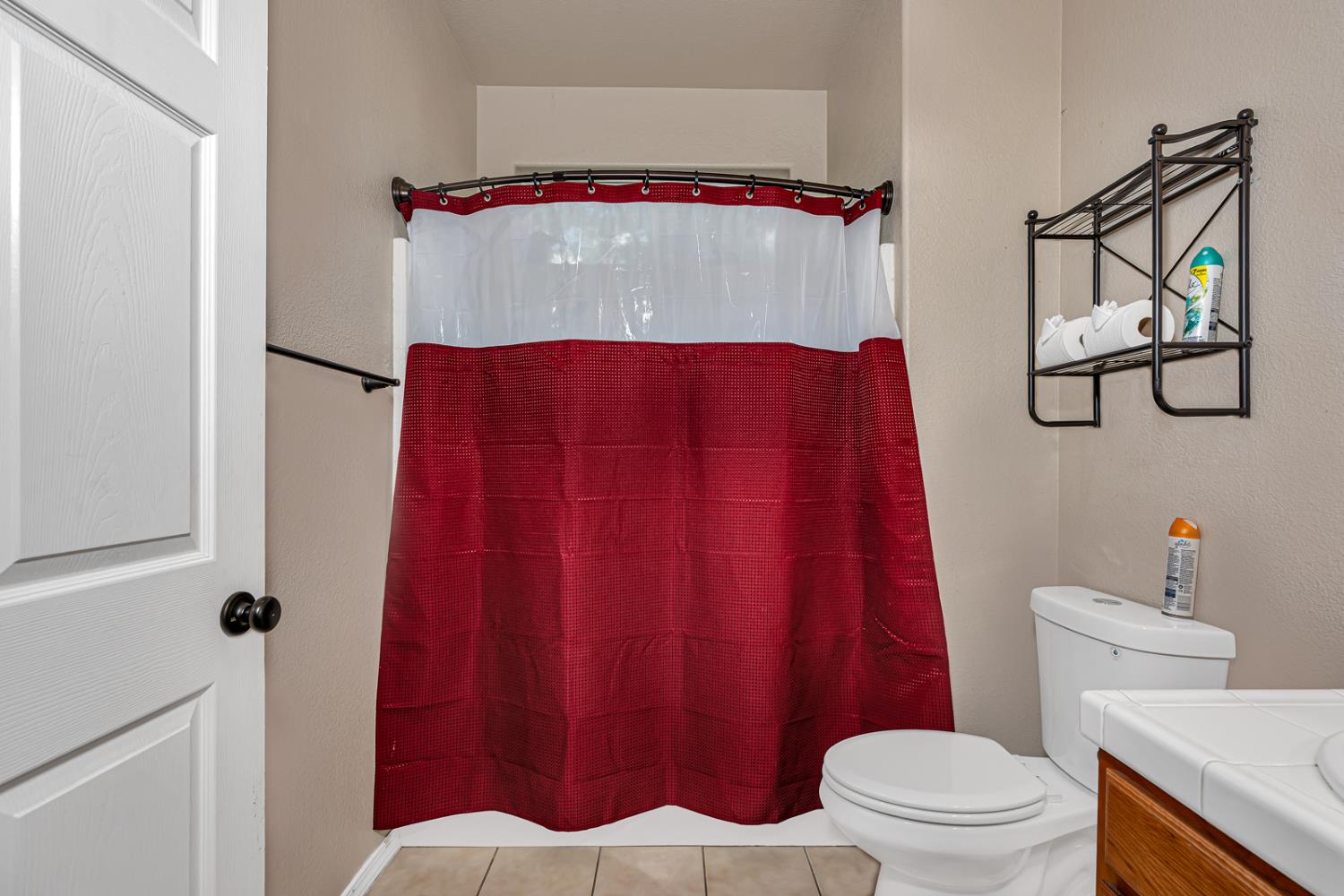 1116 West Walter Avenue, Unit 72 Fowler, CA 93625 - Photo 20 of 31 a bathroom with a toilet and a shower curtain