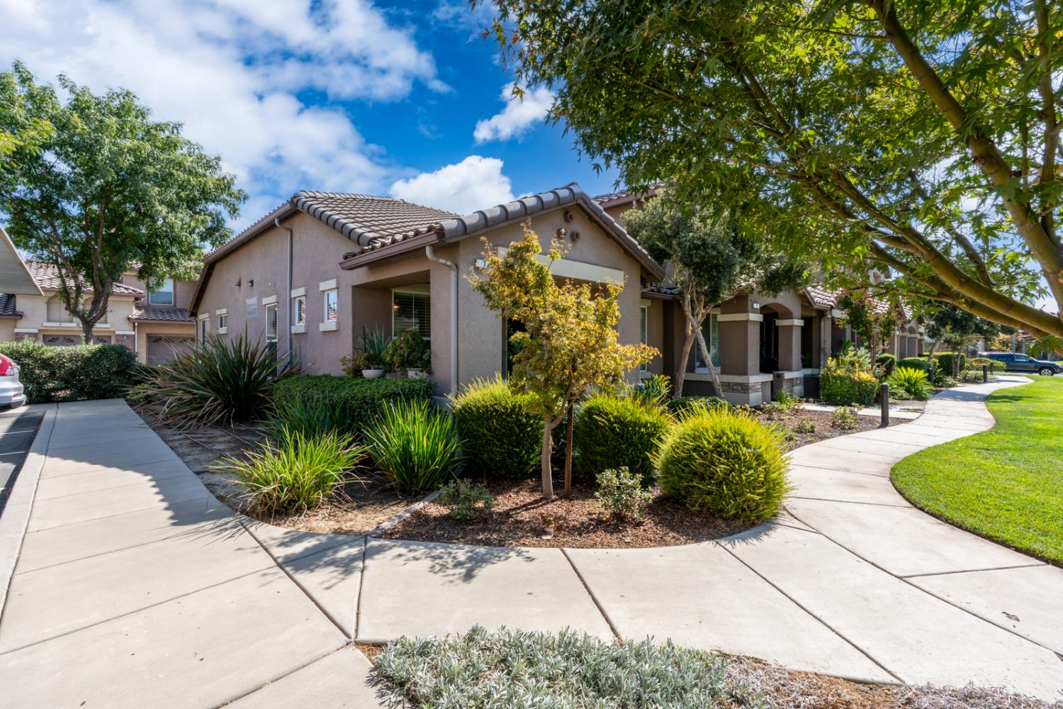 1116 West Walter Avenue, Unit 72 Fowler, CA 93625 - Photo 2 of 31 a front view of a house with garden