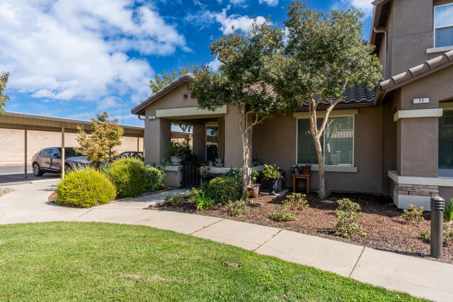 1116 West Walter Avenue, Unit 72 Fowler, CA 93625 - Photo 3 of 31 a front view of a house with garden