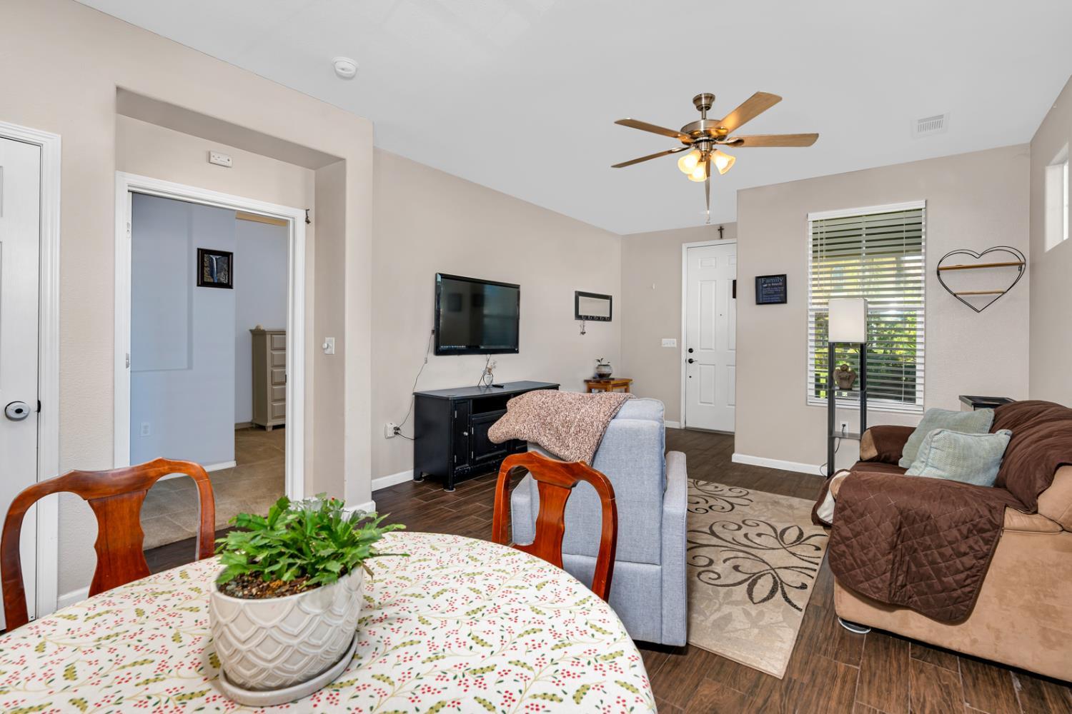 1116 West Walter Avenue, Unit 72 Fowler, CA 93625 - Photo 8 of 31 a living room with furniture potted plant and a window