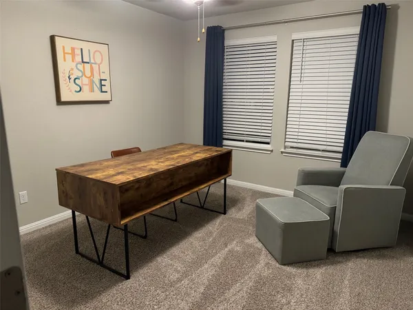 a living room with a table and a window
