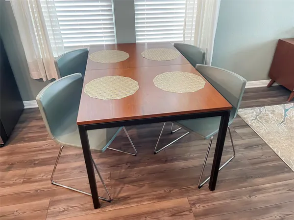 a view of a dining room with furniture and wooden floor