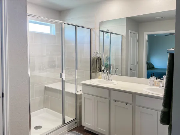 a bathroom with a double vanity sink and mirror