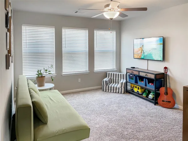 a bedroom with furniture and a large window