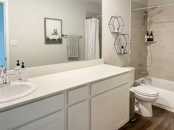 a bathroom with a sink toilet and shower