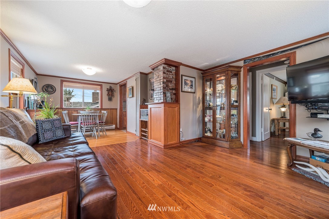 1022 North 32nd Street Renton, WA 98056 - Photo 5 of 29 a living room with furniture and a wooden floor