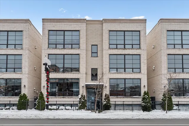 a front view of a building and garage