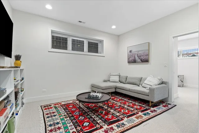 a living room with furniture a rug and a flat screen tv