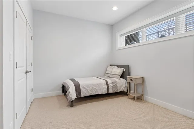 a bed room with a bed and a window