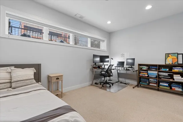 a bedroom with furniture and a book shelf