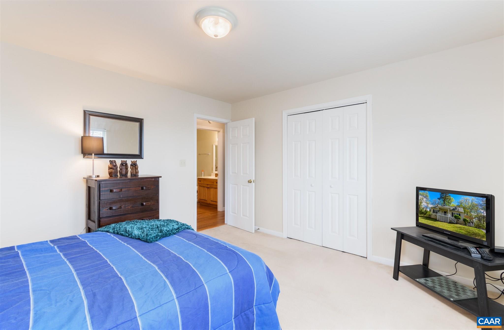 322 East Daffodil Road Ruckersville, VA 22968 - Photo 16 of 28 a bedroom with a bed and a tv on a dresser