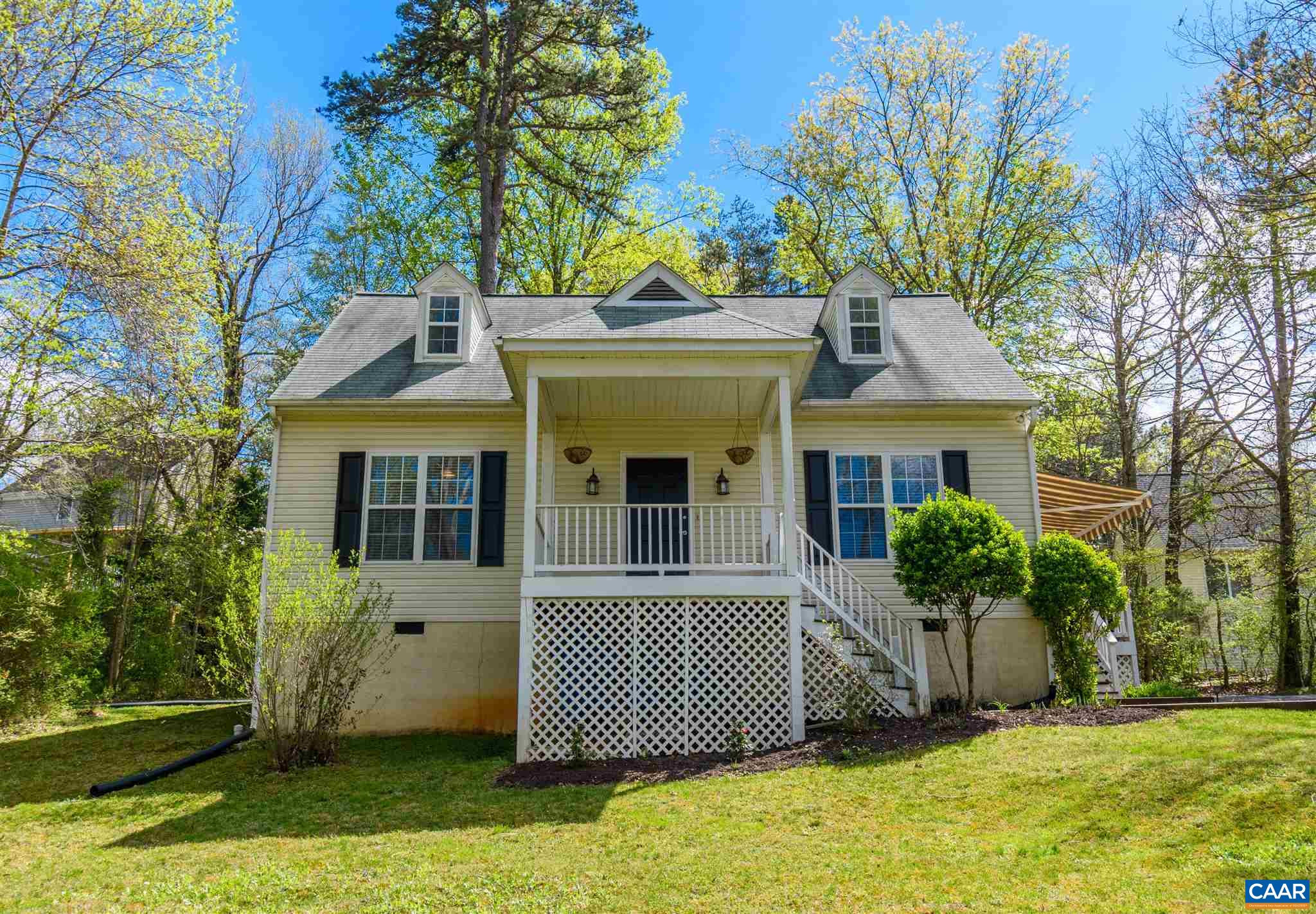322 East Daffodil Road Ruckersville, VA 22968 - Photo 2 of 28 a view of a brick house with a yard plants and large tree