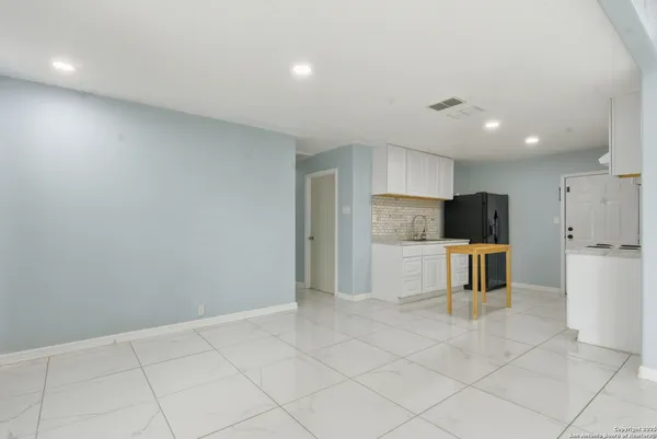 a large kitchen with white cabinets