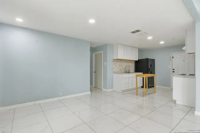 a large kitchen with white cabinets