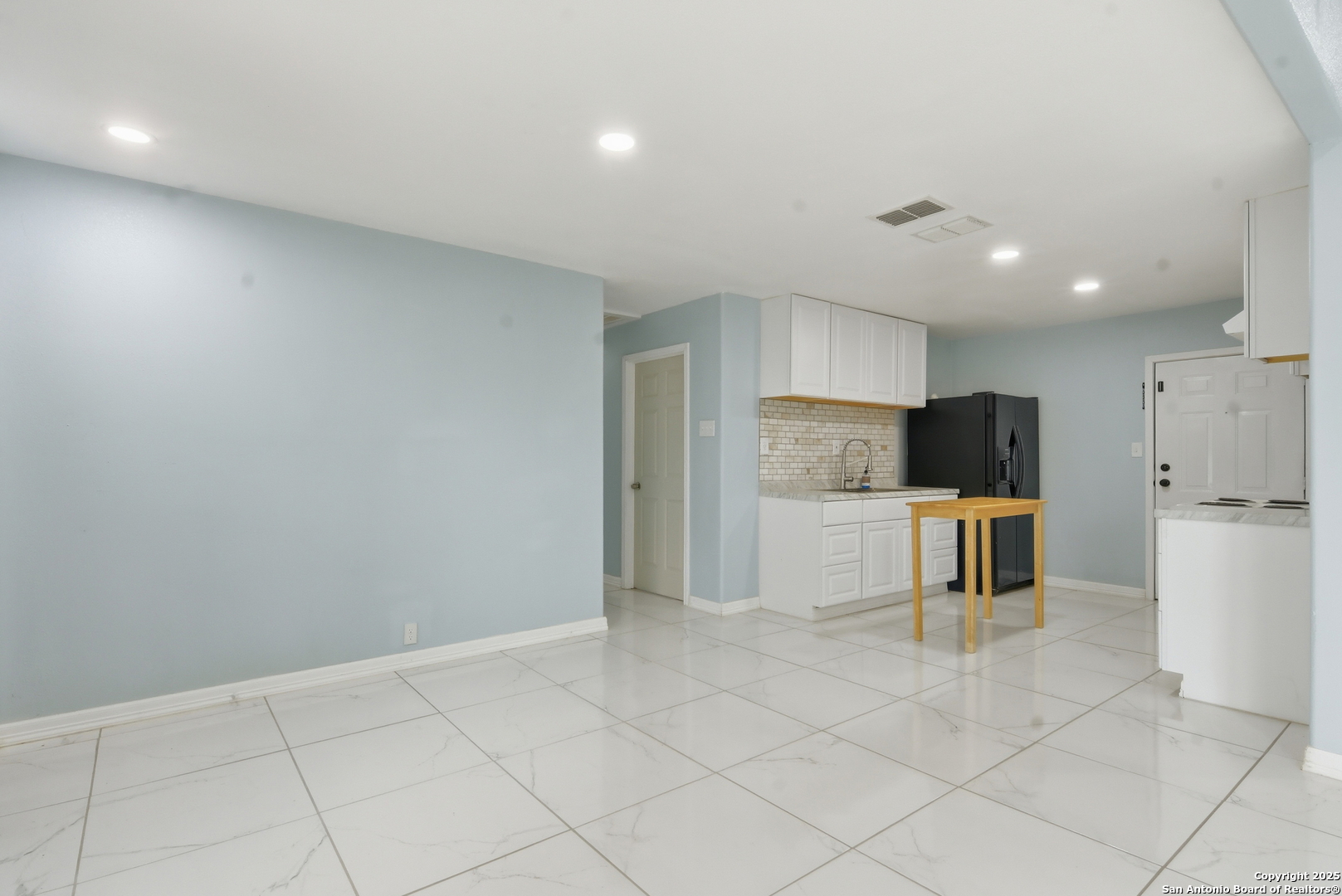 521 Old Carrizo Road Uvalde, TX 78801 - Photo 11 of 31 a large kitchen with white cabinets