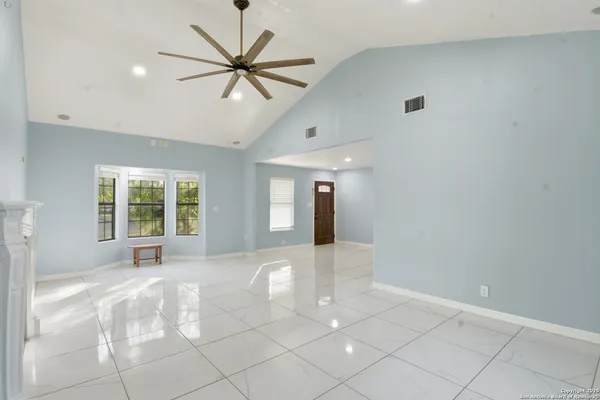 a view of a livingroom with a ceiling fan and window