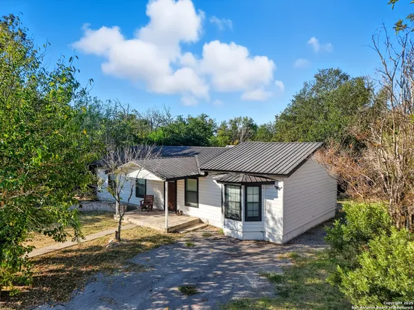 a aerial view of a house with a yard and sitting area