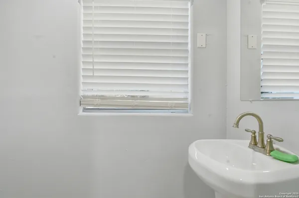 a bathroom with a sink and a window