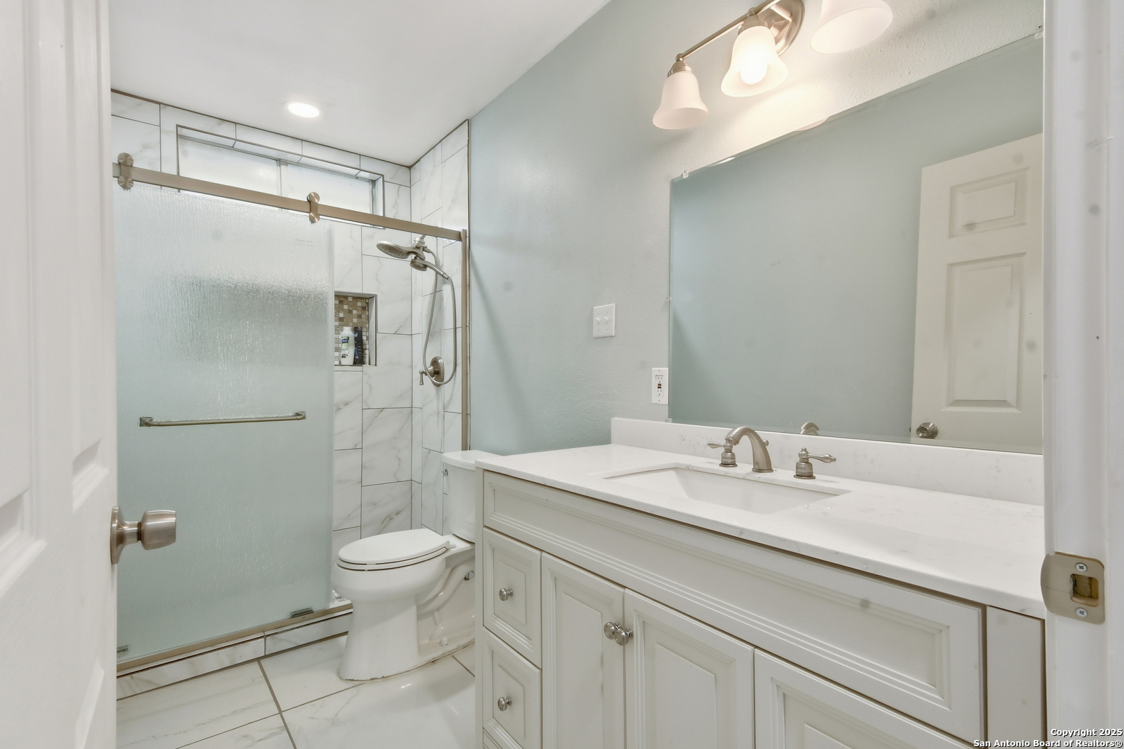 521 Old Carrizo Road Uvalde, TX 78801 - Photo 25 of 31 a bathroom with a sink toilet double vanity and shower