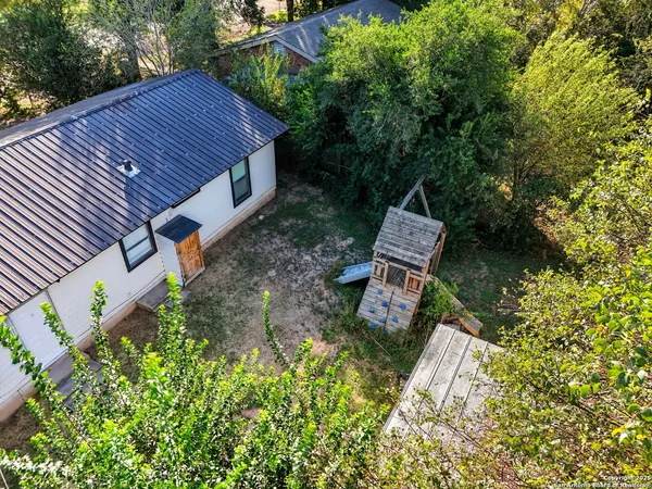 a view of house with backyard and trees