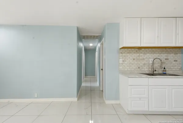 a bathroom with a sink and cabinets