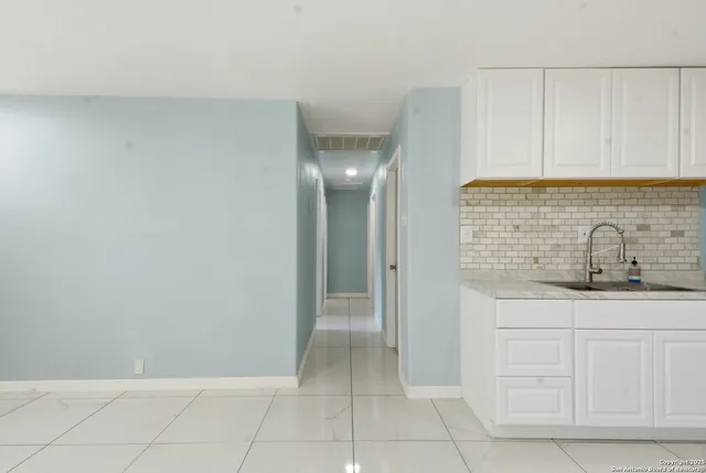 a bathroom with a sink and cabinets
