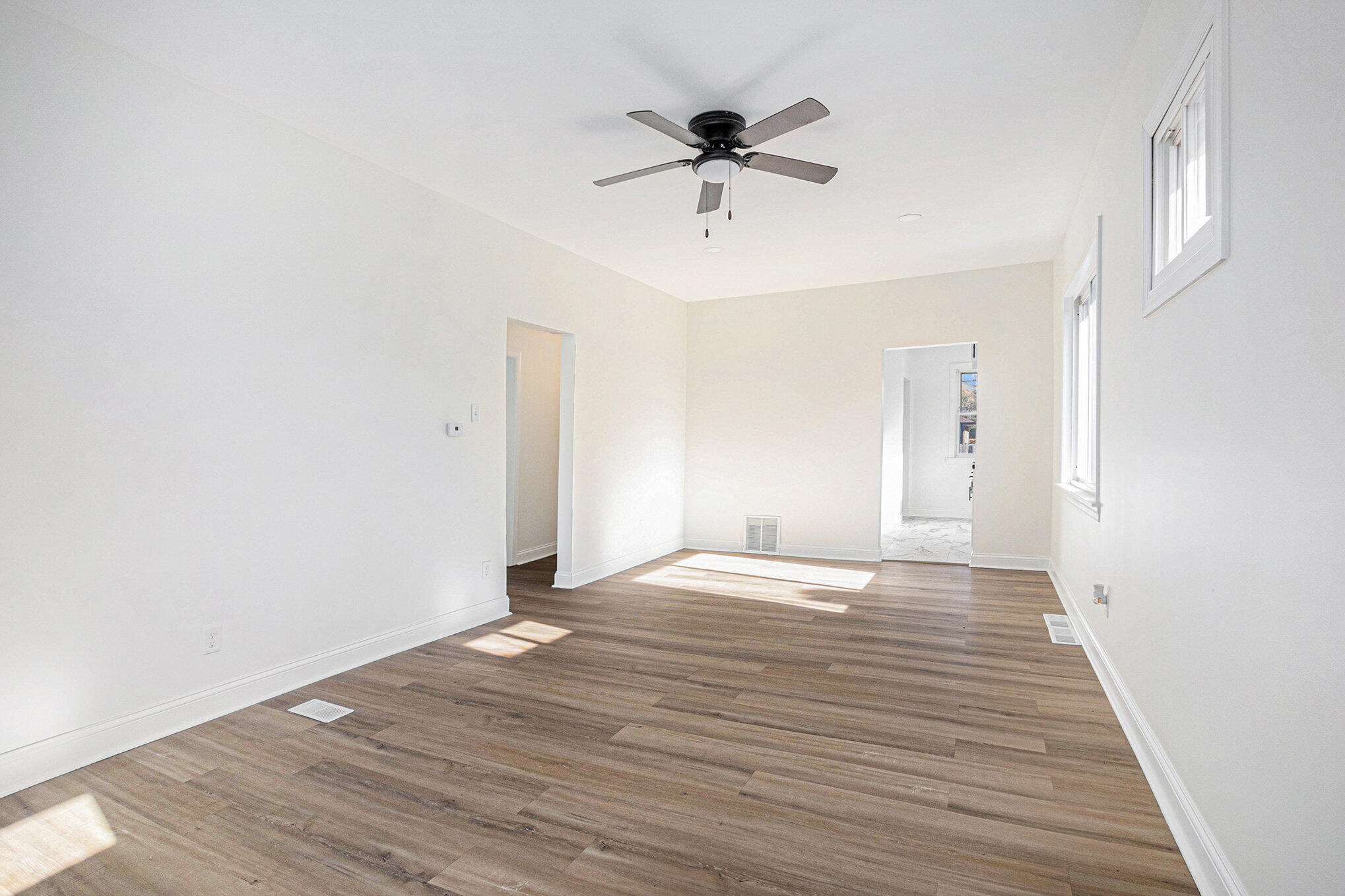 3625 Virginia Street Gary, IN 46409 - Photo 3 of 15 a view of an empty room with a window and wooden floor