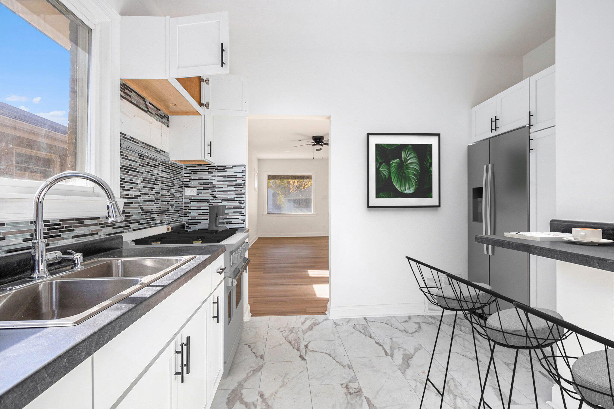 3625 Virginia Street Gary, IN 46409 - Photo 4 of 15 a kitchen with stainless steel appliances a sink and a refrigerator