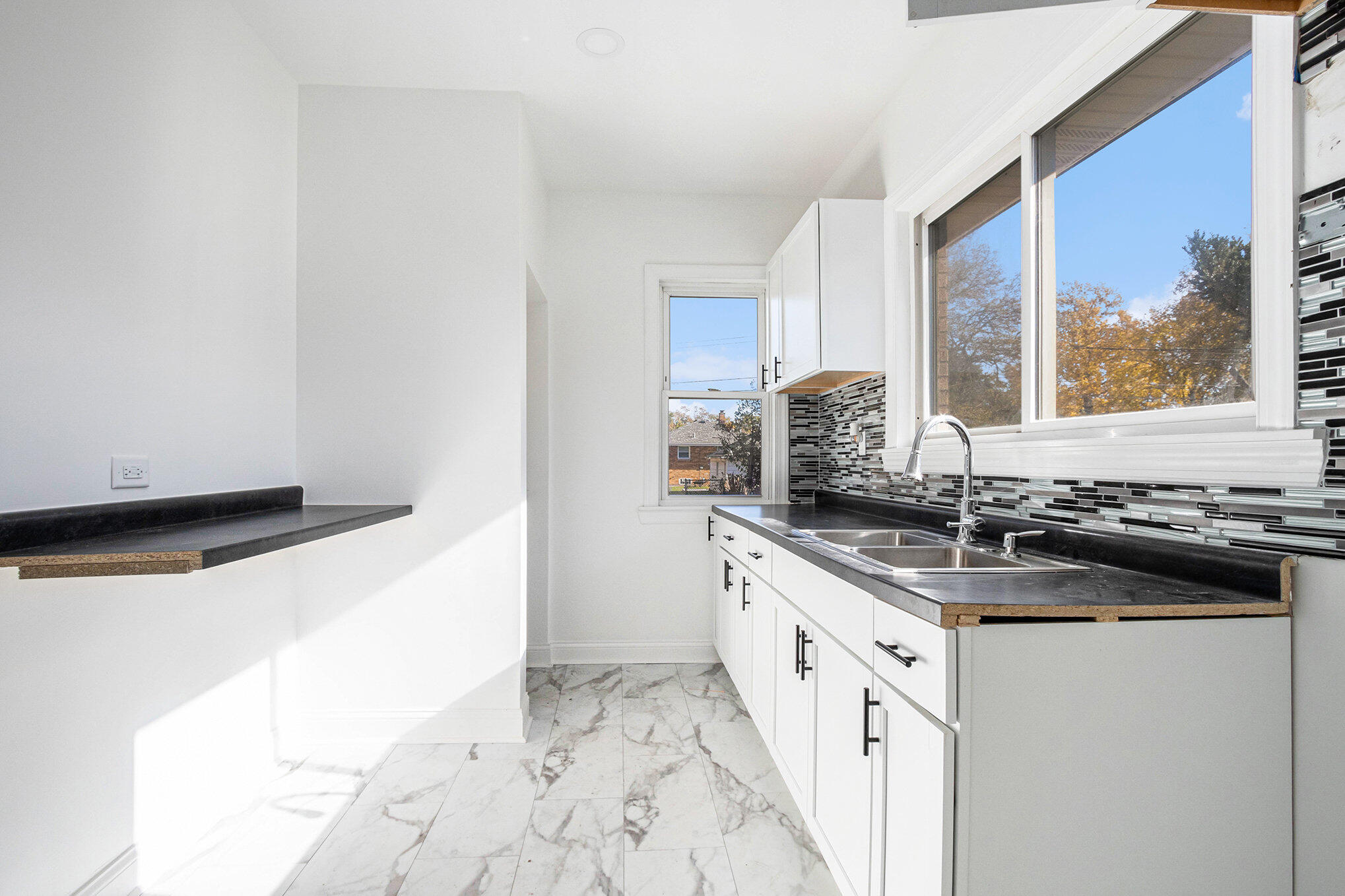 3625 Virginia Street Gary, IN 46409 - Photo 6 of 15 a kitchen with granite countertop a sink and a stove