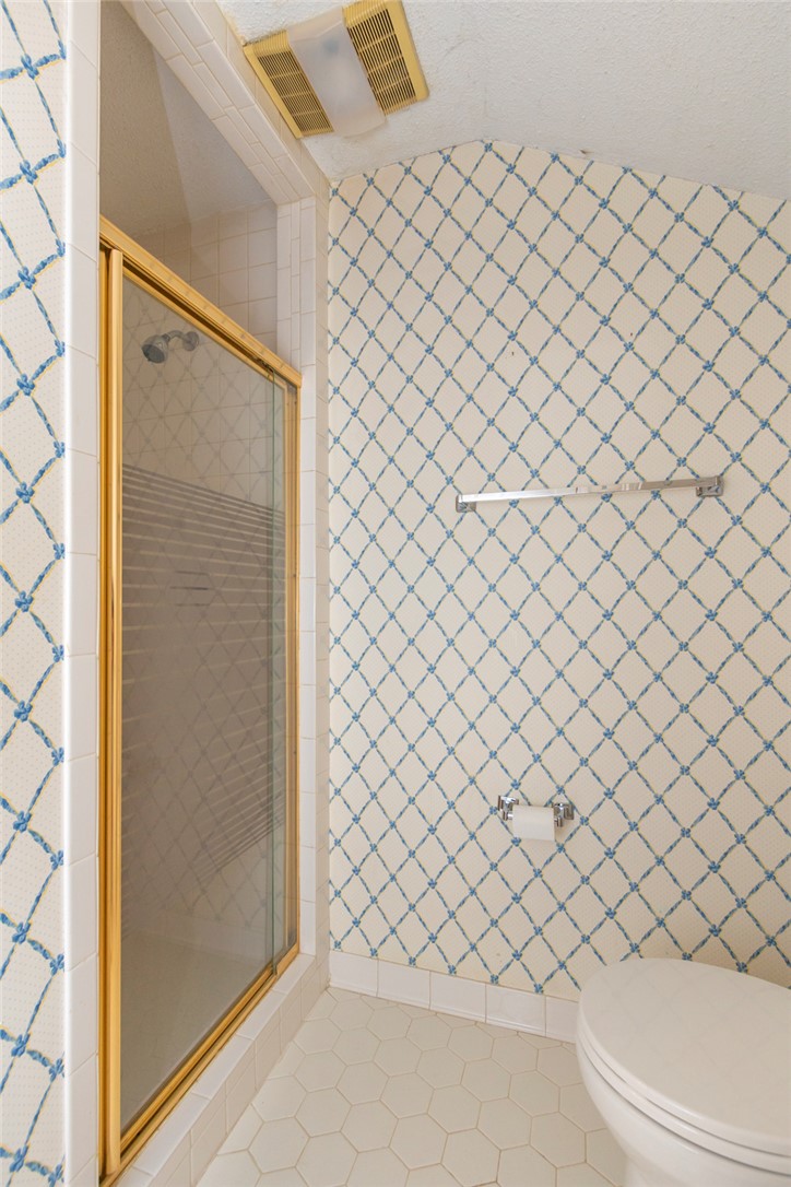 1302 Leeward Road Anderson, SC 29625 - Photo 22 of 50 A well-maintained bathroom with a tiled shower stall and a toilet.