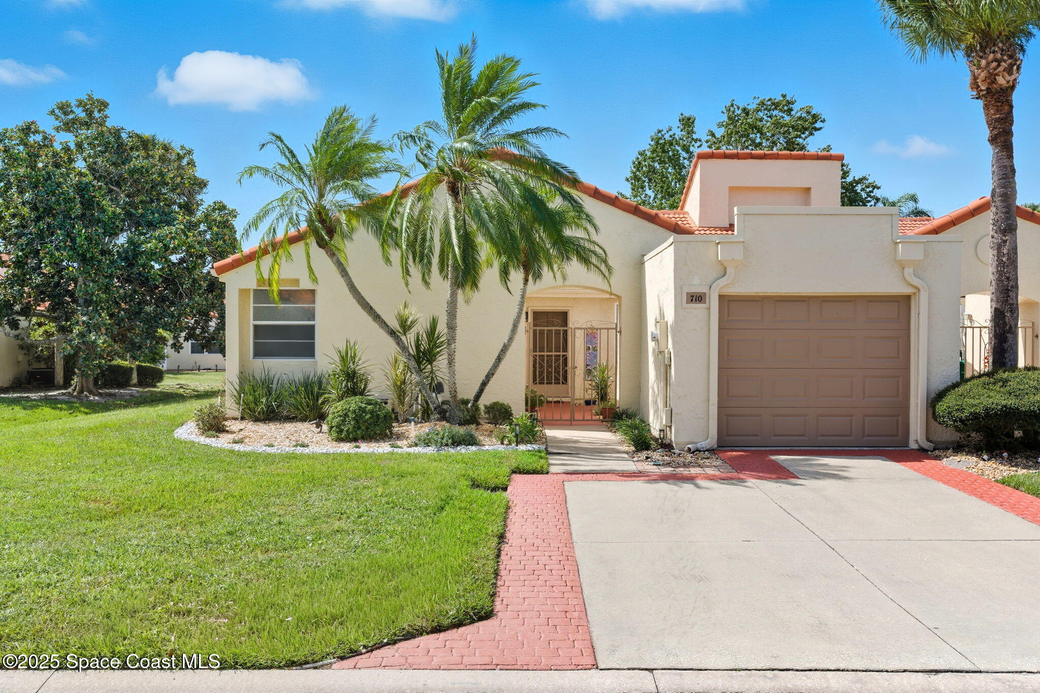 a front view of a house with yard and green space