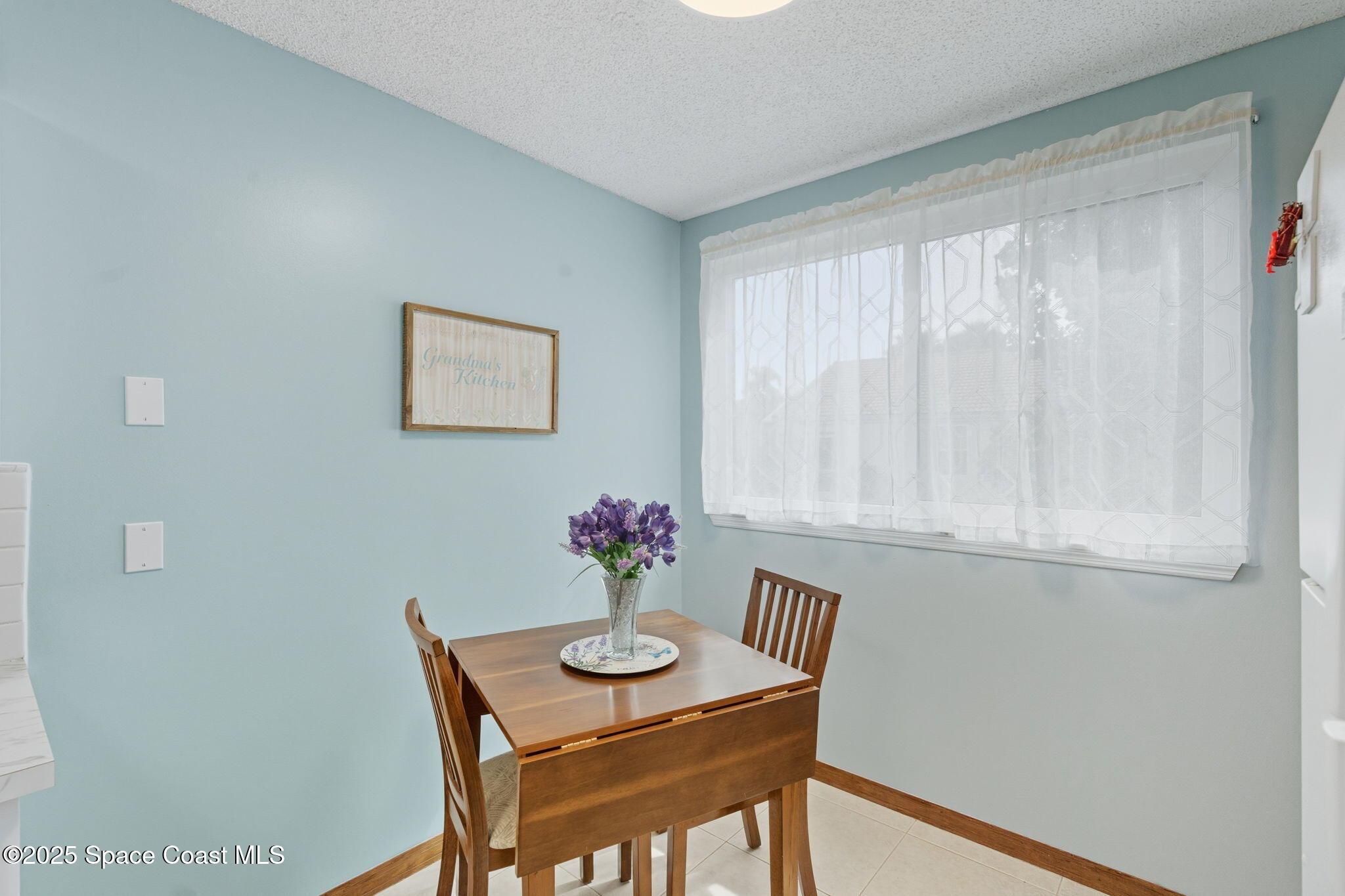 710 Spring Valley Drive Melbourne, FL 32940 - Photo 11 of 30 a view of a dining room with furniture and wooden floor