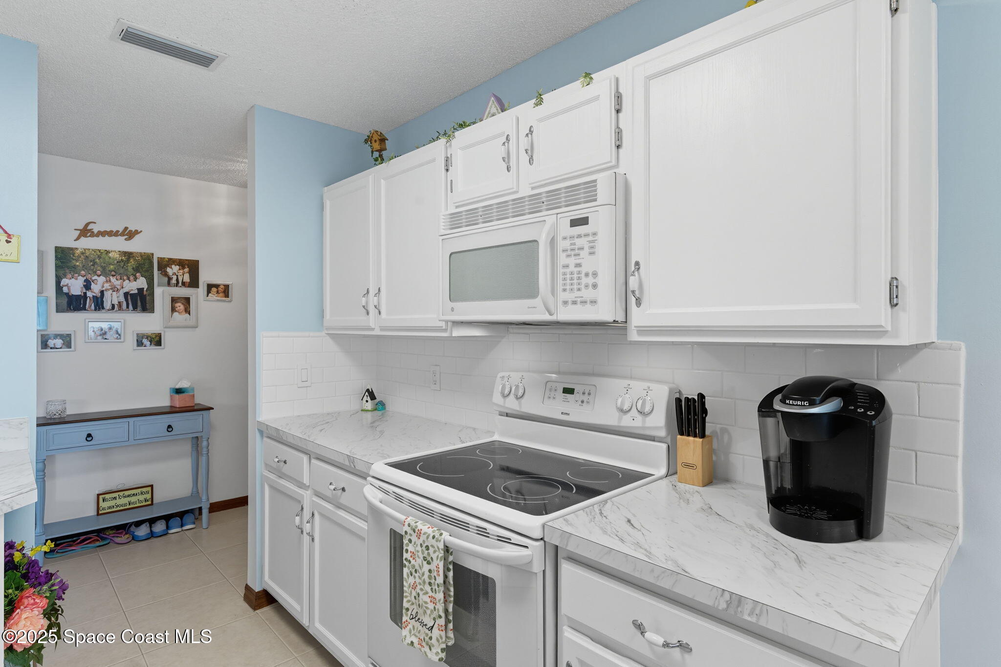710 Spring Valley Drive Melbourne, FL 32940 - Photo 12 of 30 a kitchen with cabinets and appliances
