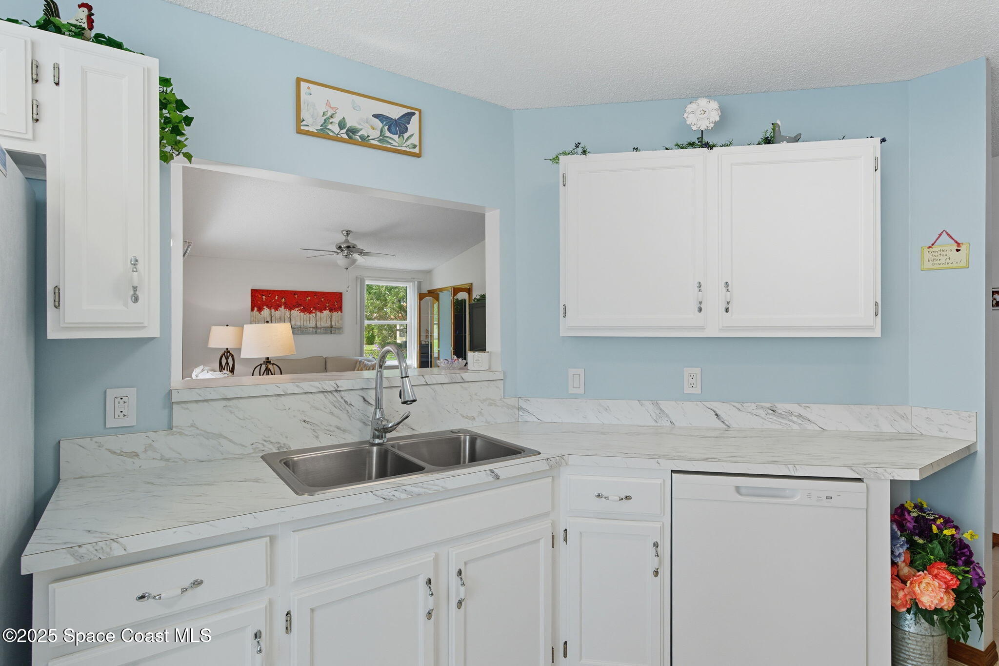 710 Spring Valley Drive Melbourne, FL 32940 - Photo 13 of 30 a kitchen with a sink and cabinets