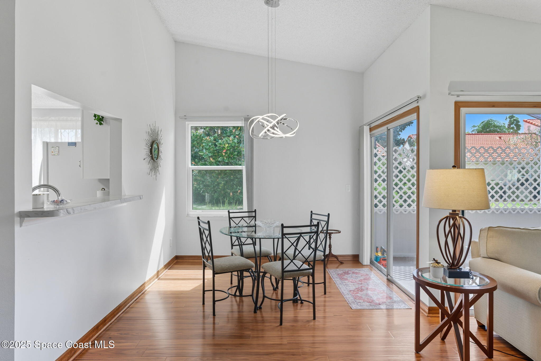 710 Spring Valley Drive Melbourne, FL 32940 - Photo 15 of 30 a view of a dining room with furniture window and wooden floor