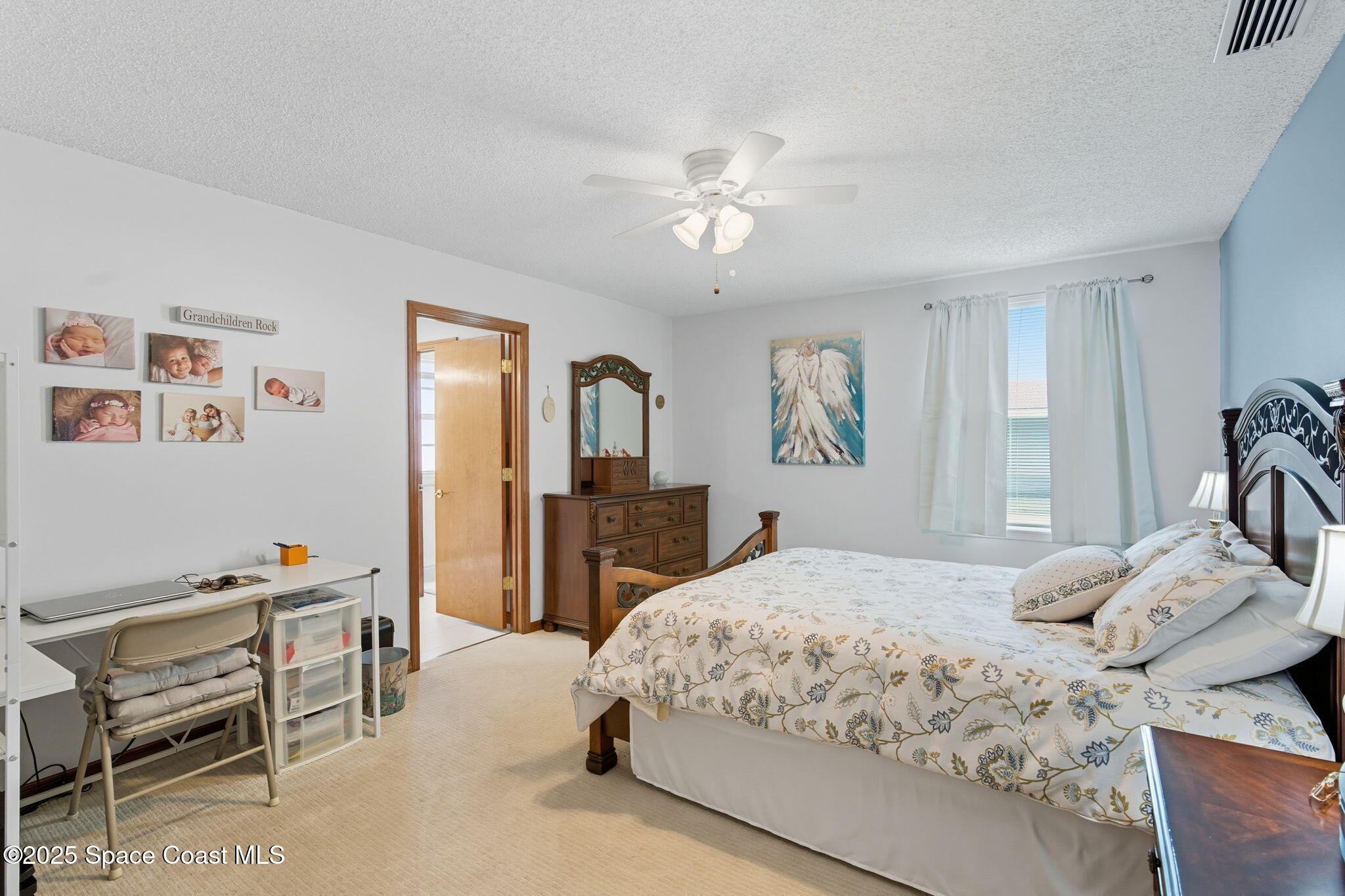 710 Spring Valley Drive Melbourne, FL 32940 - Photo 17 of 30 a bedroom with a bed and a view of kitchen